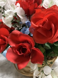 A vibrant bouquet of mixed flowers arranged in a rustic wicker basket.