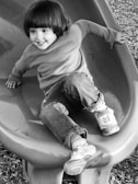 A child playing happily under the supervision of a caregiver.