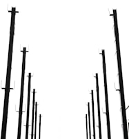 Rows of custom metal frames hanging and drying in a factory.