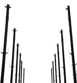 Rows of custom metal frames hanging and drying in a factory.