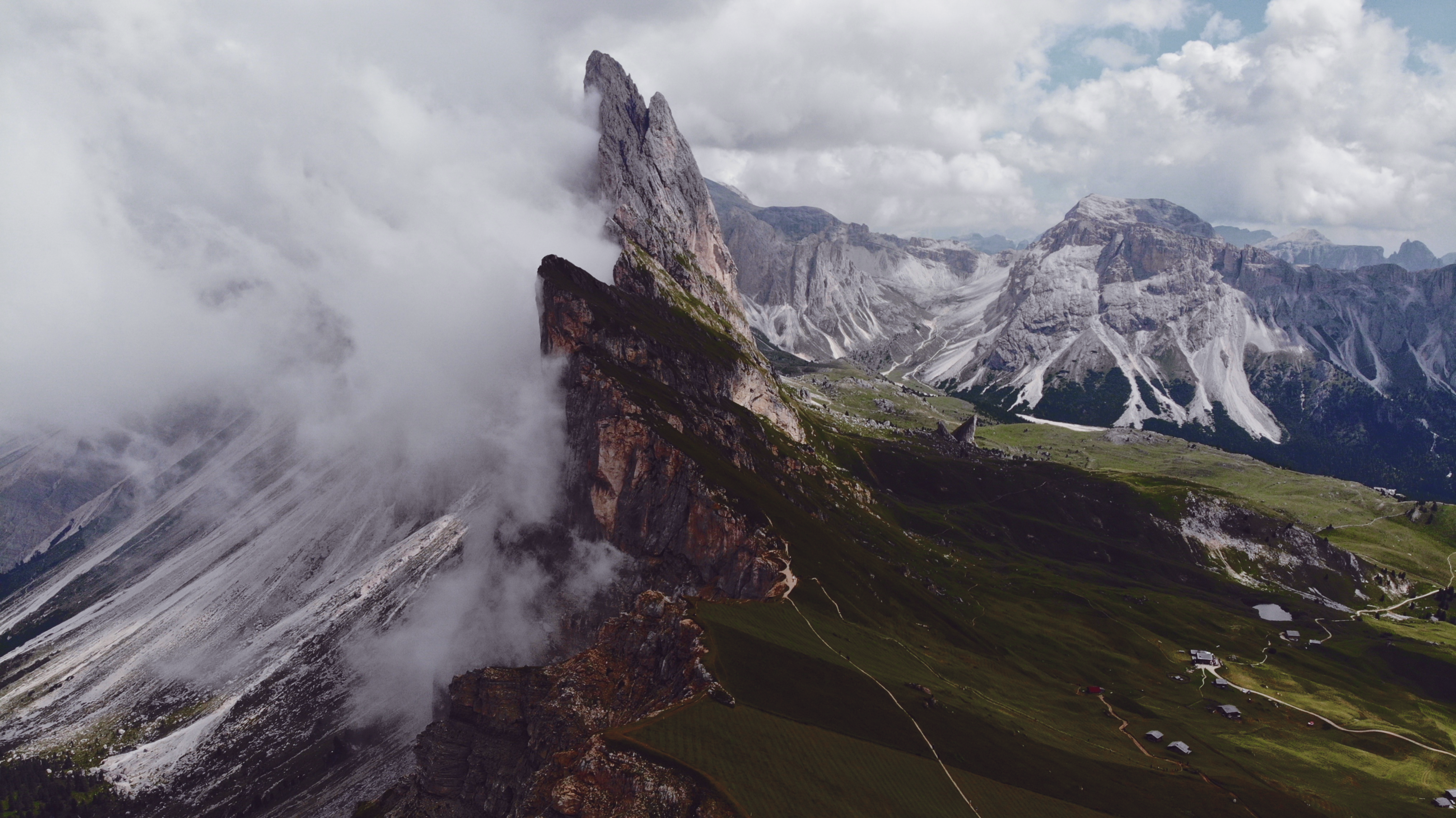 green field and mountain covered with fogs