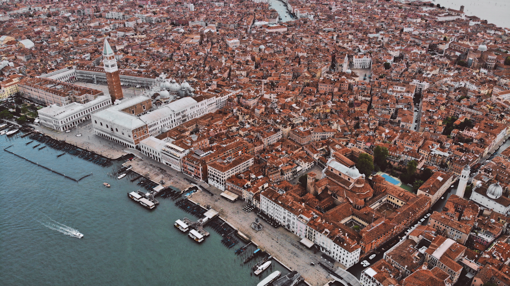 grey and brown concrete buildings near body of water during daytime