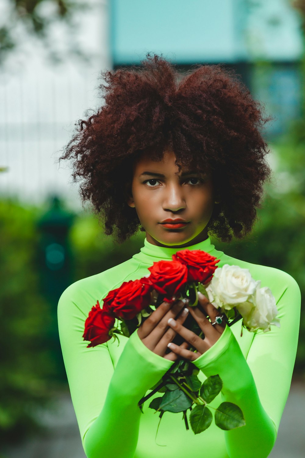 woman holding red and white rose flowers