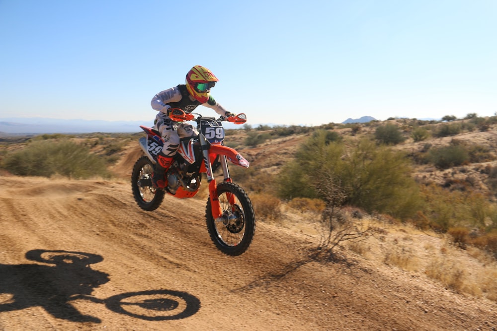 man drives motocross bike downhill