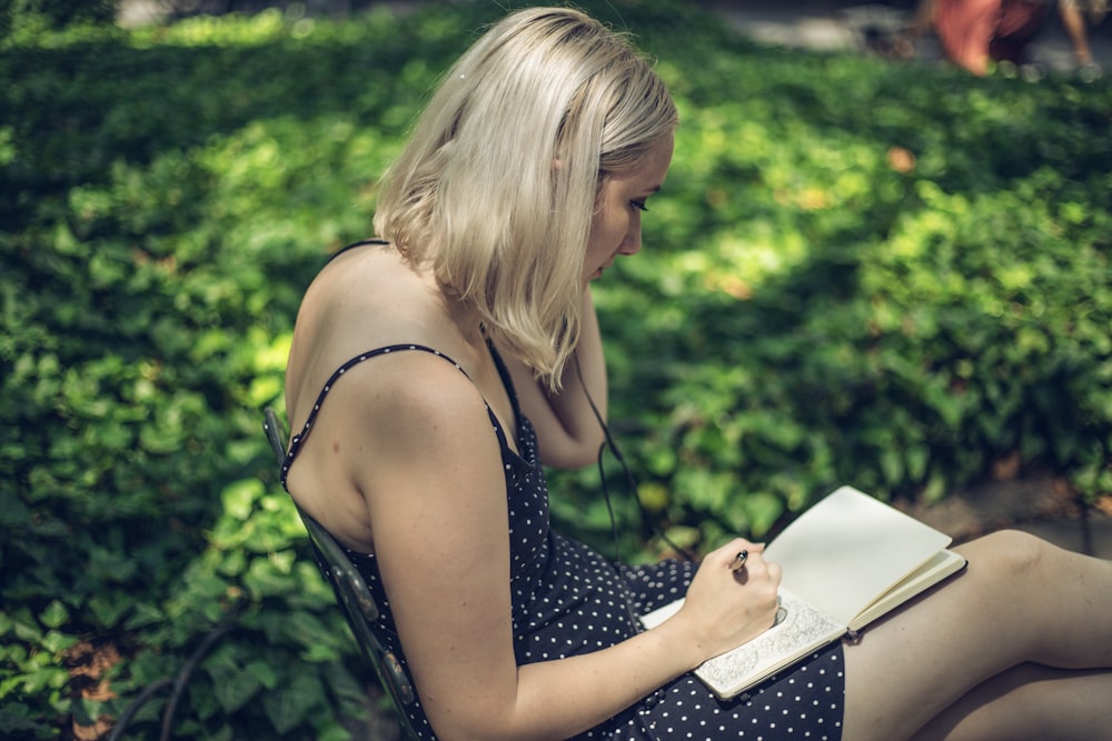 woman writing on notebook