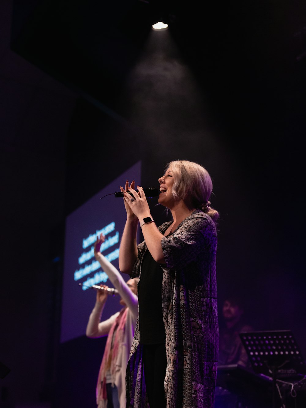 woman singing on stage