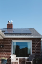 brown brick house with solar panels on roof