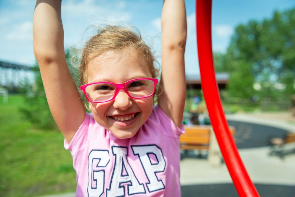 girl wears pink framed eyeglasses