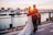 Smiling couple enjoying a sunset boat tour near the iconic Cabo San Lucas arch.