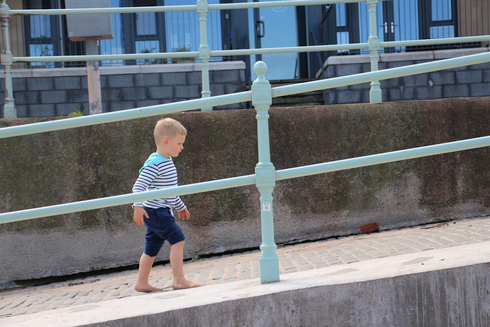 boy walking on concrete stari