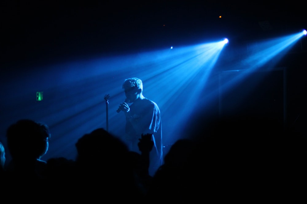 photo of man performing on stage