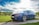 A gleaming car parked outside with a clear blue sky.
