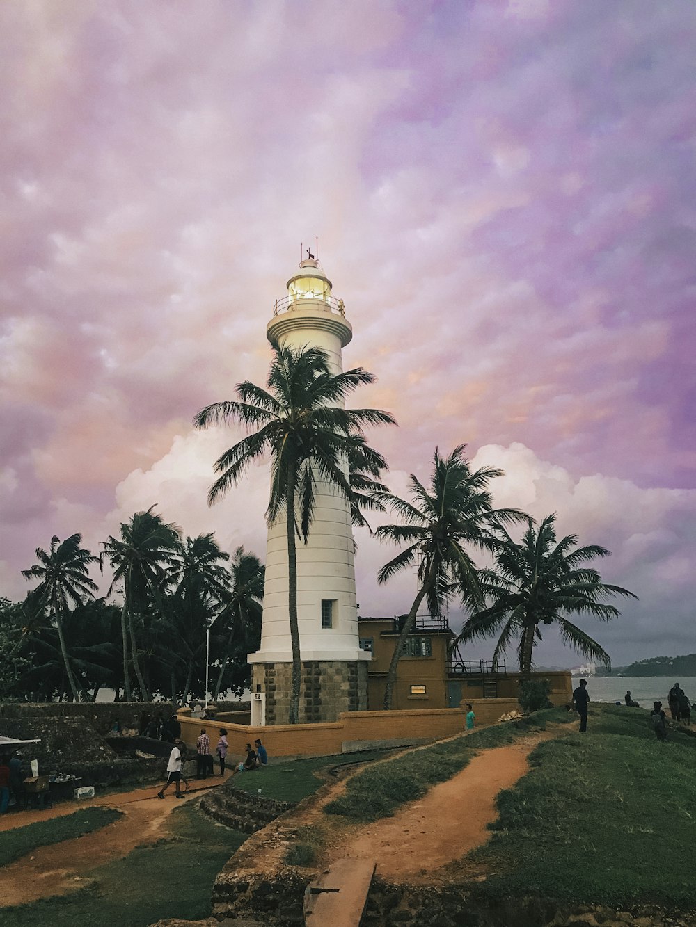 lighthouse tower under cloudy sky