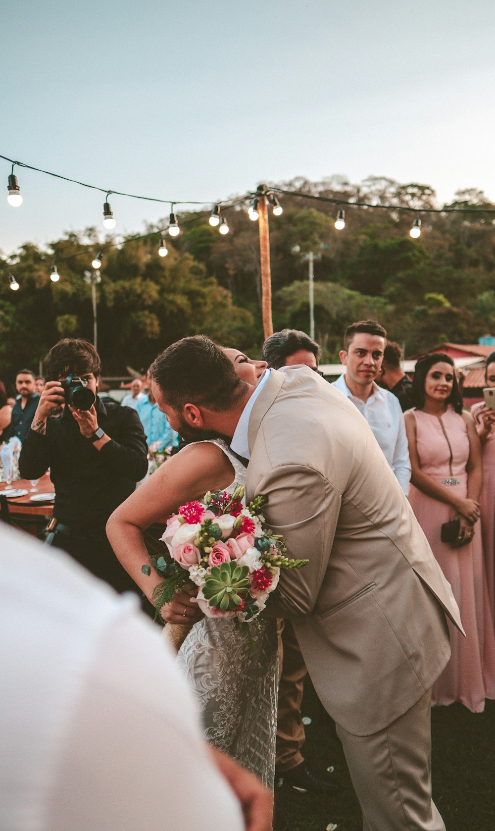 man and woman hugging surrounded with people