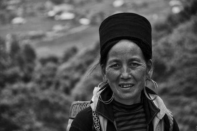 A black-and-white portrait of a woman from an indigenous community, her eyes reflecting strength and history.