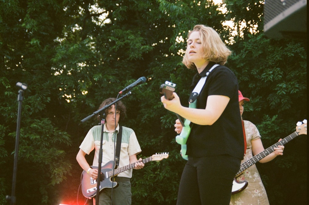 shallow focus photo of woman playing guitar