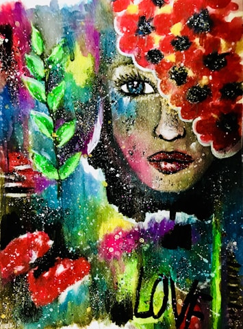 A vivid and abstract painting featuring a woman's face partially covered with bright red flowers. Her expressive blue eye stands out, surrounded by vibrant colors including green leaves to the side. The word 'LOVE' is painted in bold black letters on the lower part of the image, with splashes and dots of various colors scattered throughout the background.