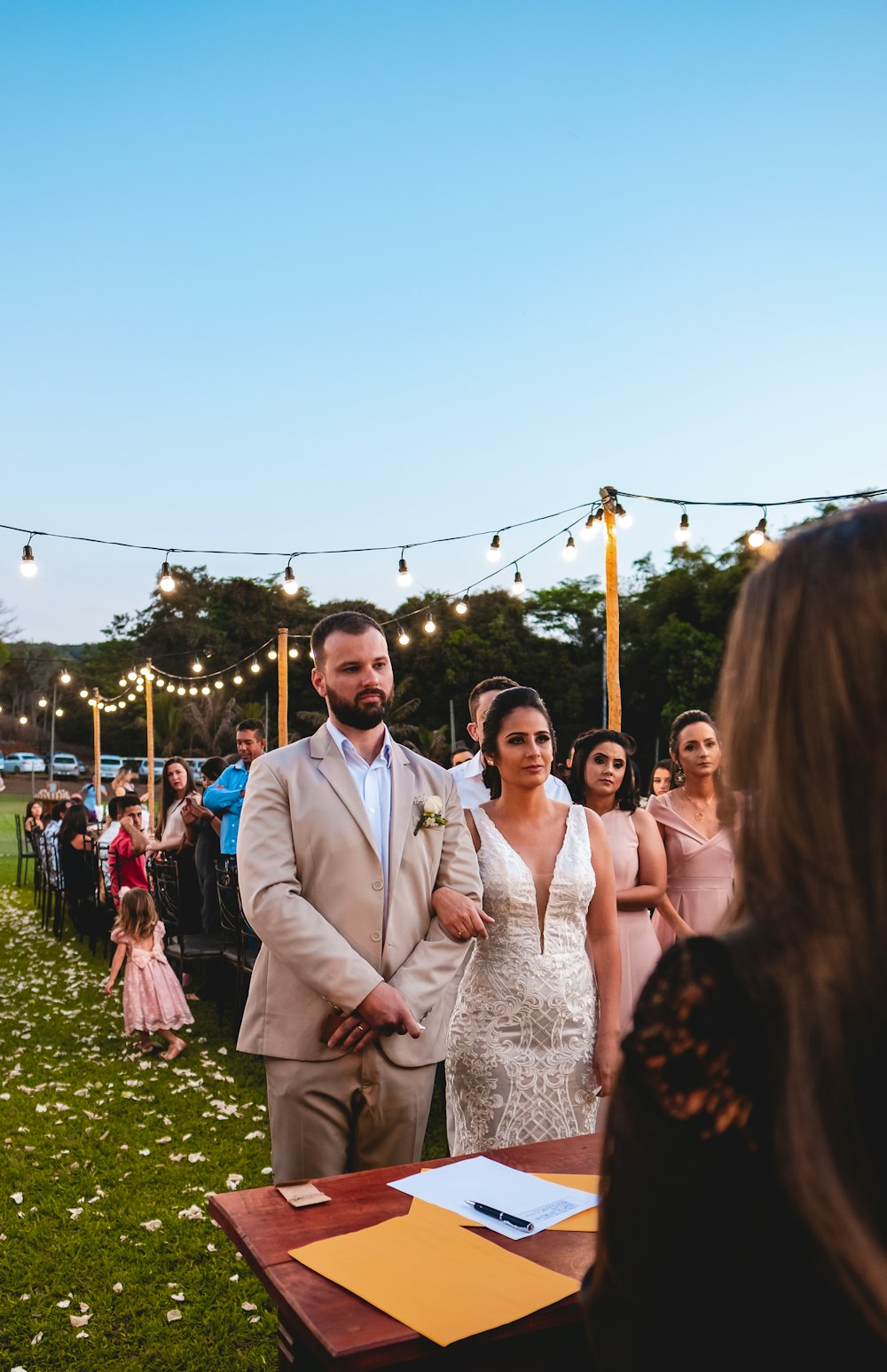 wedding in an open field under a calm blue sky