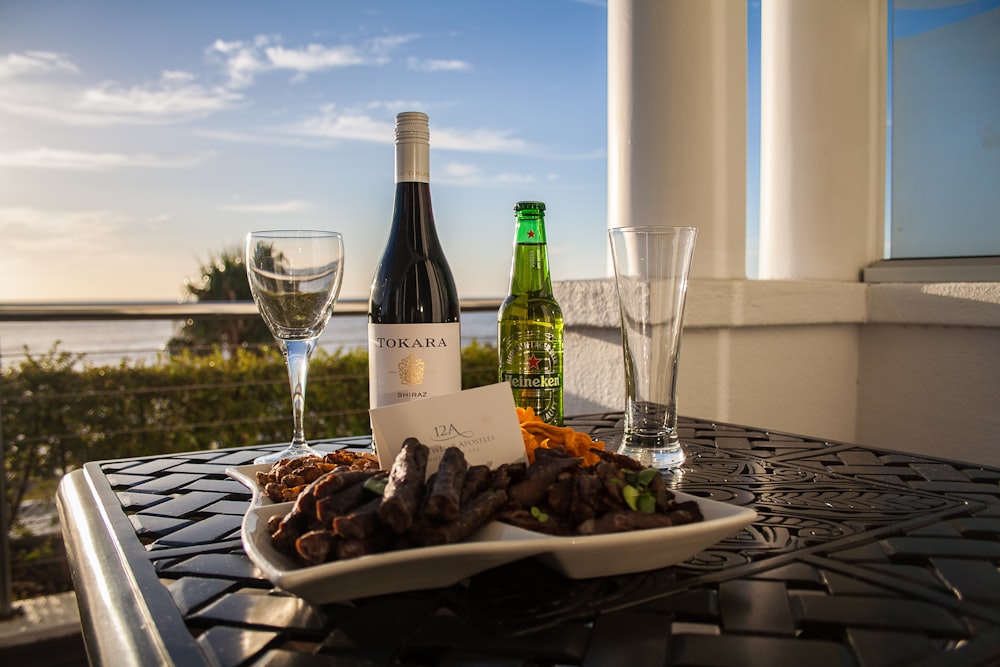 sausage beside wine bottle and wine glass