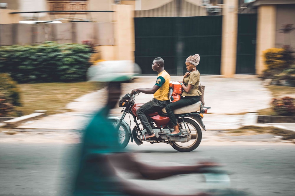 man and woman riding motorcycle