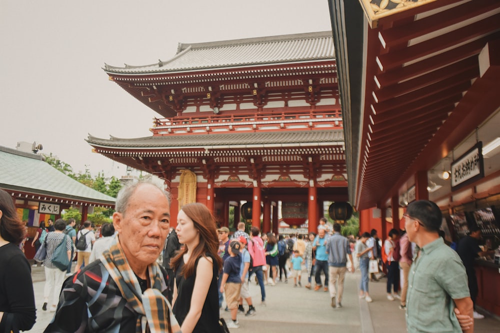 man standing near red temple