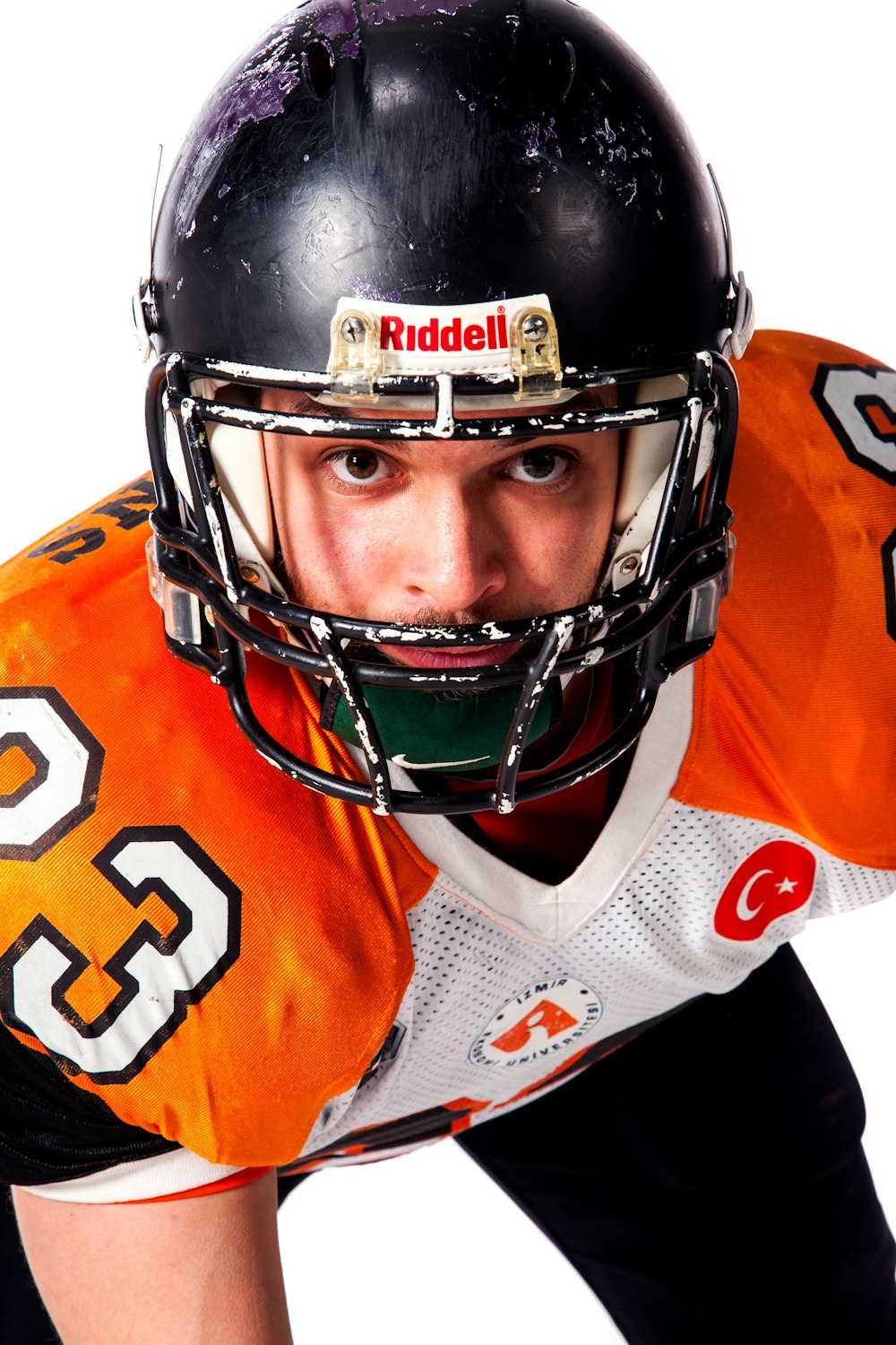 man wears black Riddell helmet close-up photography