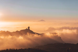 Sunrise over Machu Picchu with mist curling through ancient stone terraces.