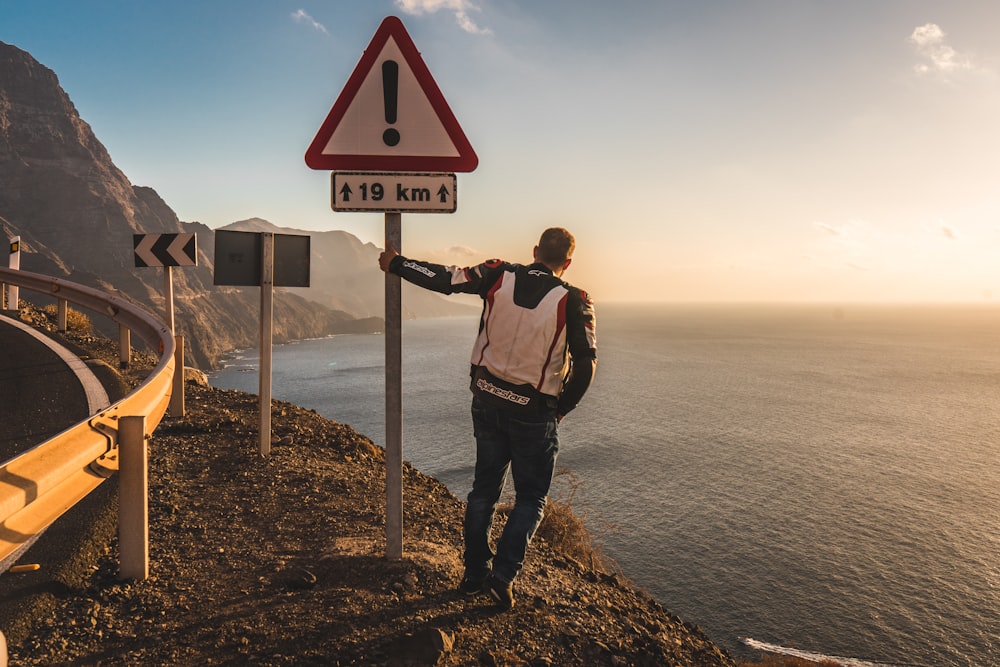 man standing on street signage