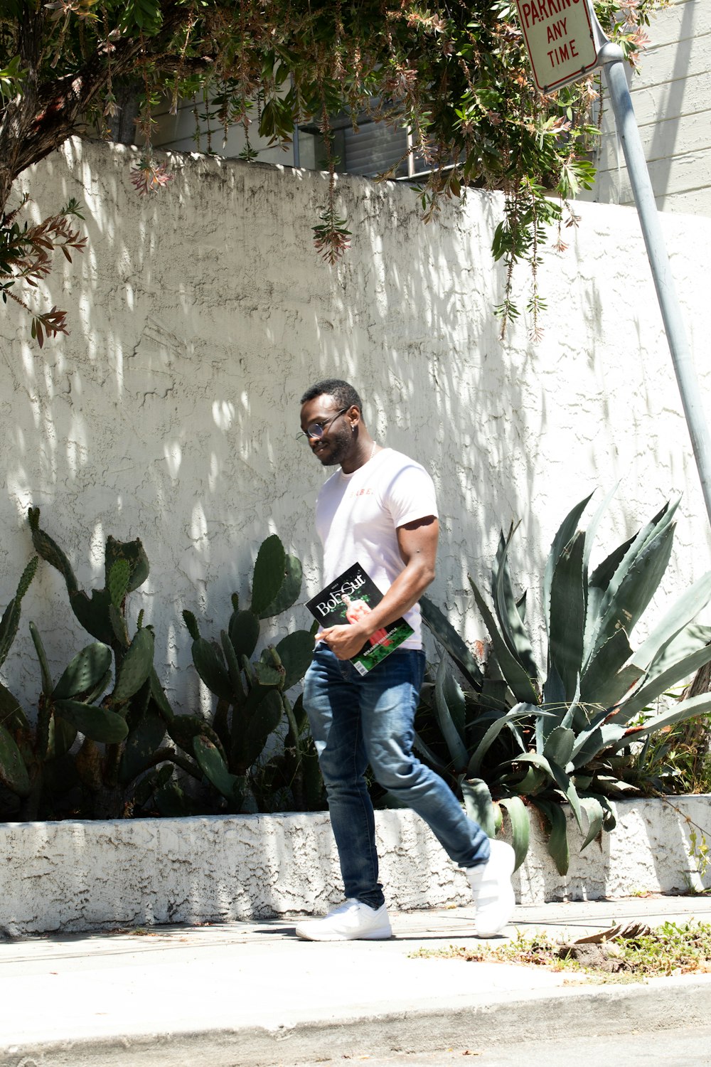 man walking on sidewalk on focus photography