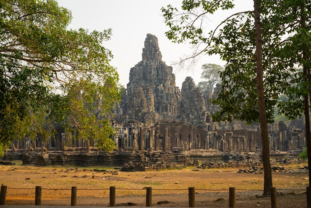 Bayon Temple in Cambodia surrounded with tall and green trees