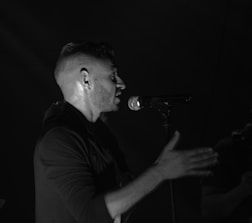 An intimate scene of a poet passionately delivering a performance on a dimly lit stage.