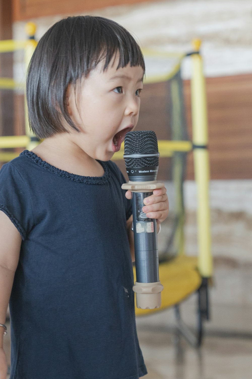 girl in black blouse olding microphone