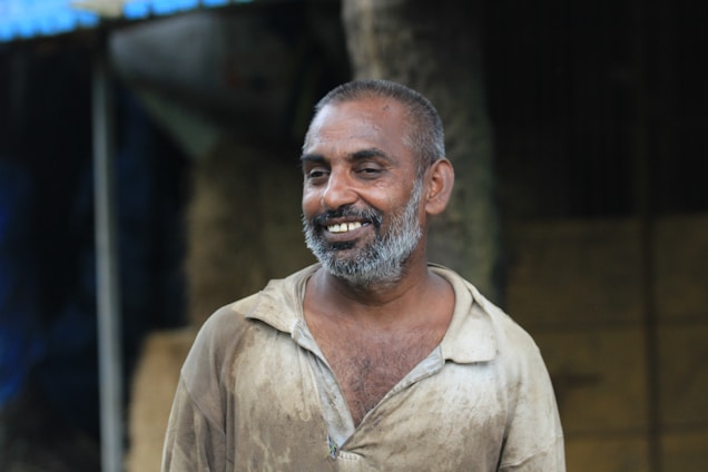 A warm, inviting photo of a middle-aged man smiling confidently, symbolizing renewed vitality and strength.