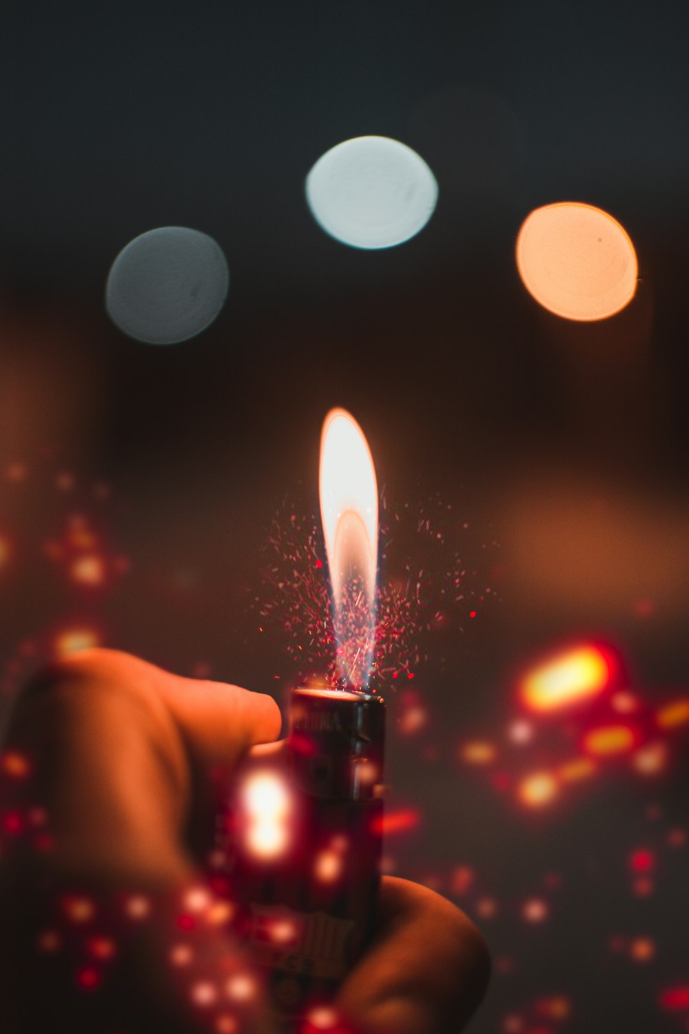 person holding lit lighter