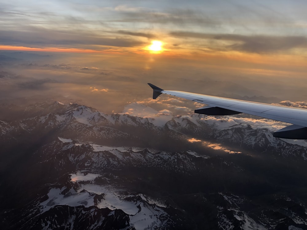 passenger plane flying under golden hour