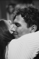 A cozy scene of two people sharing a warm hug, smiles breaking through.