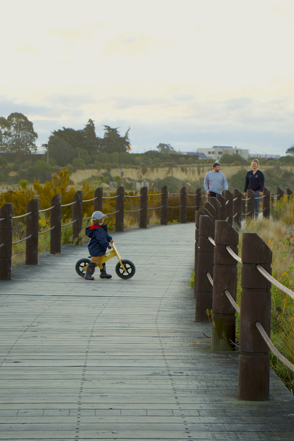 boy playing balance bike