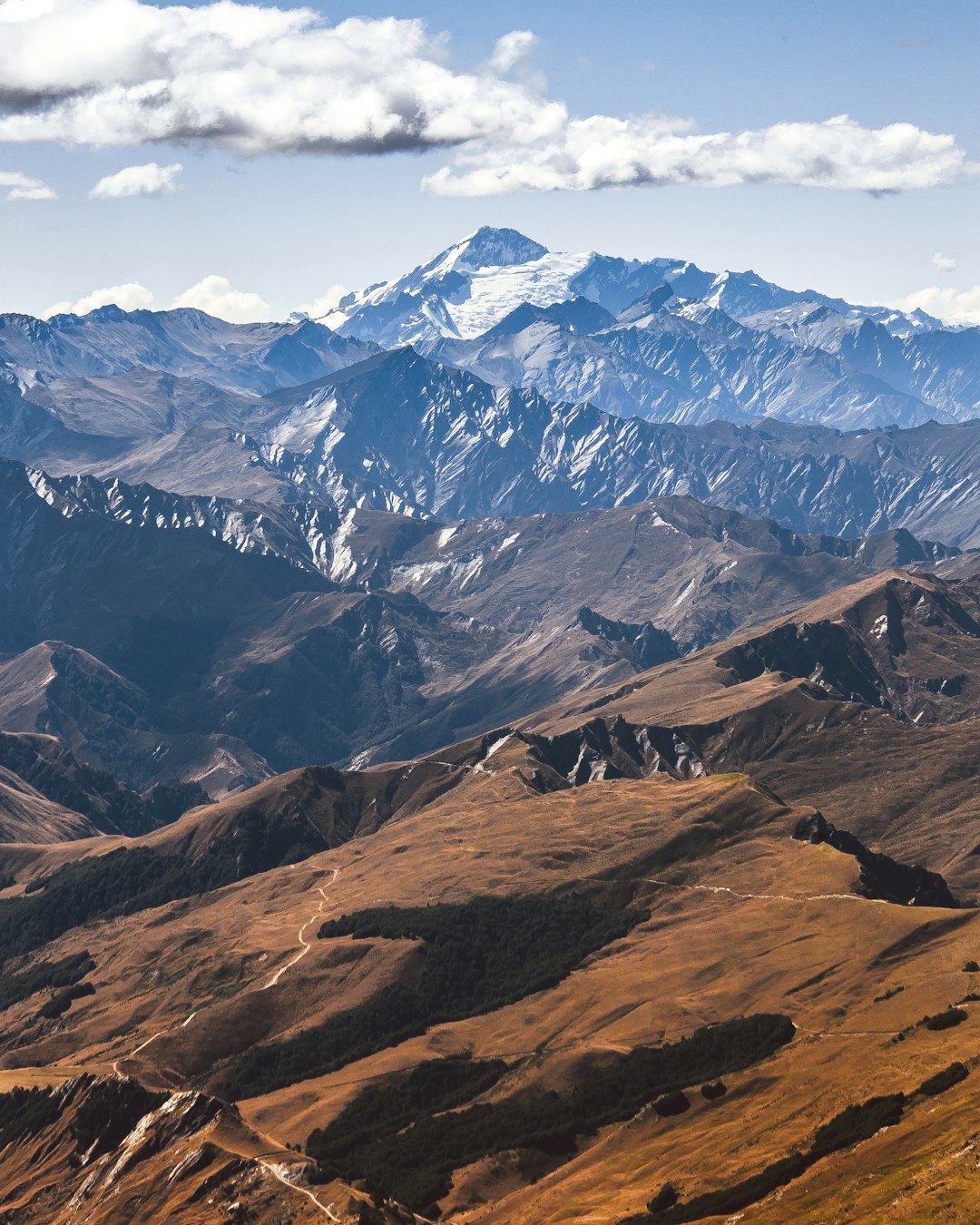 mountain range under clouded sky