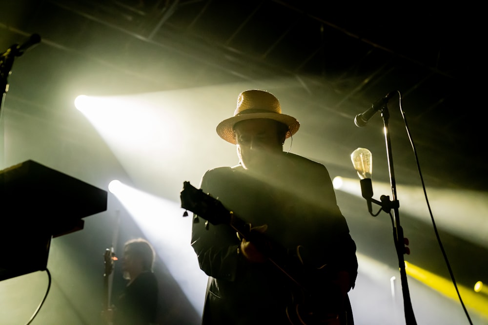 silhouette of man playing guitar