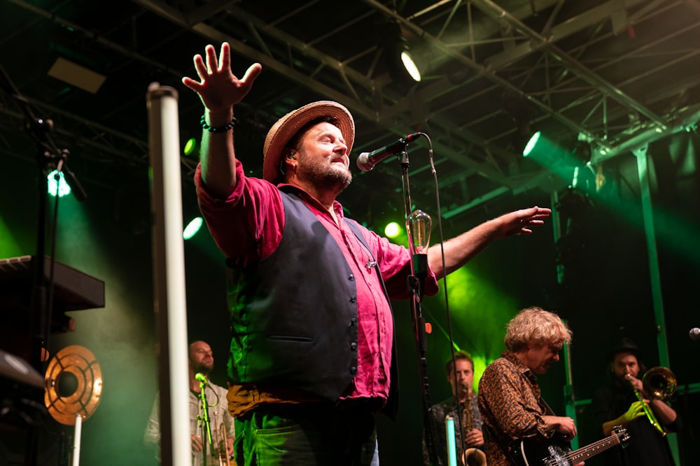 man singing on stage