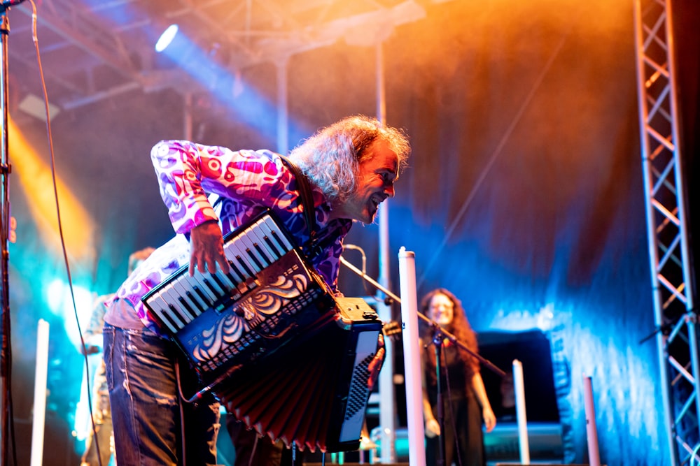 man playing accordion near woman