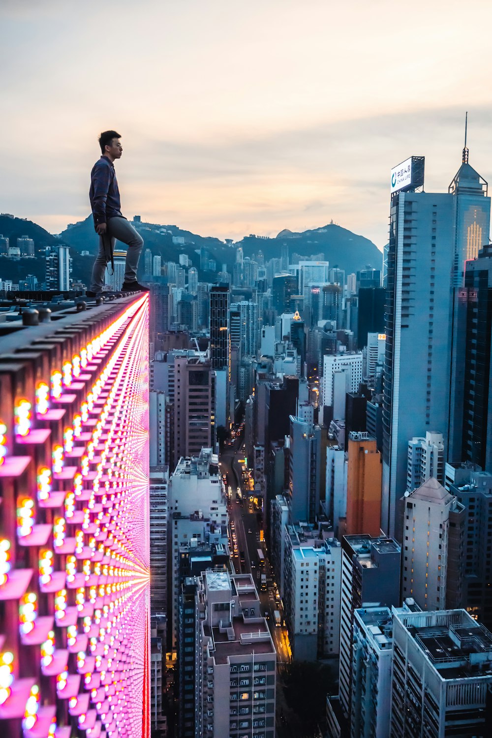 man on roof in city