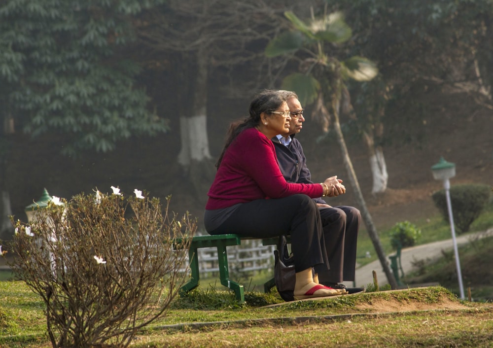 two people sitting on bench