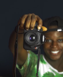 A candid shot of Joe Wade behind the camera, focused and smiling during a shoot.