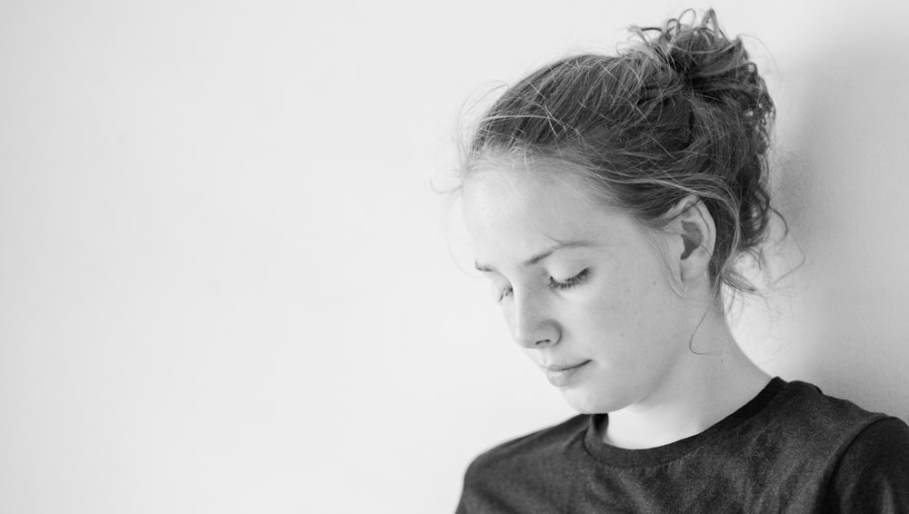 woman leans on wall