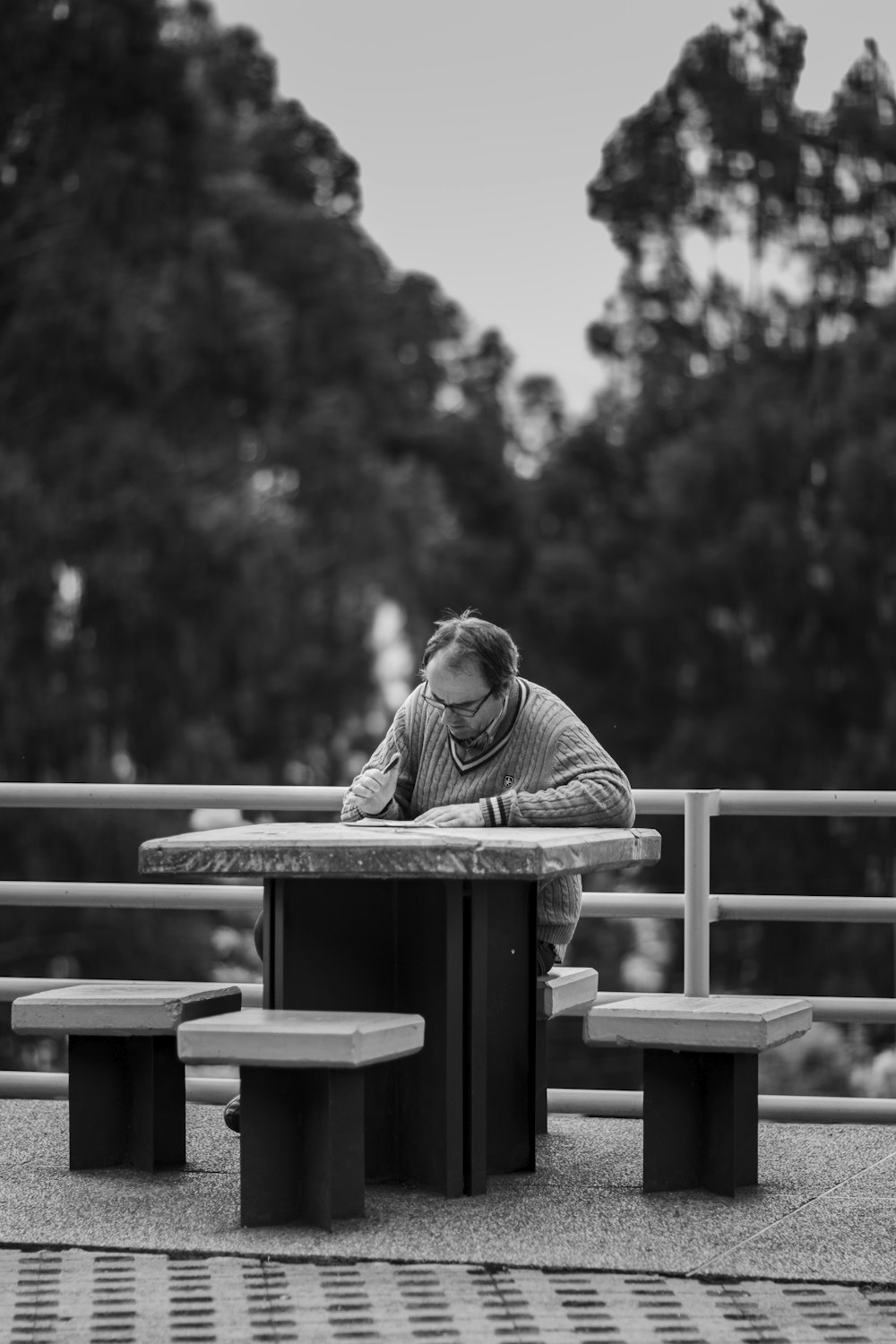 grayscale photography of man writing