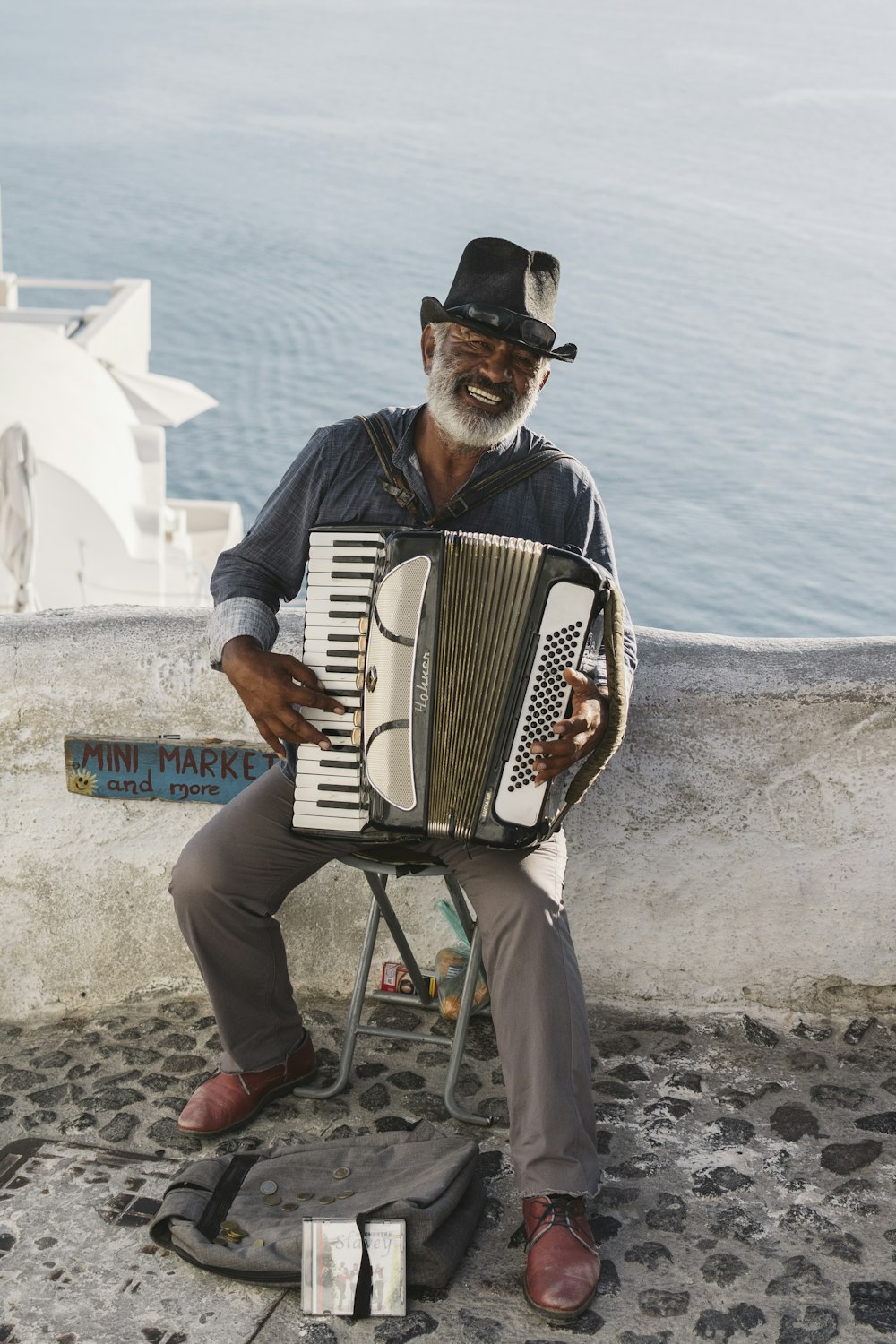 man playing white accordion