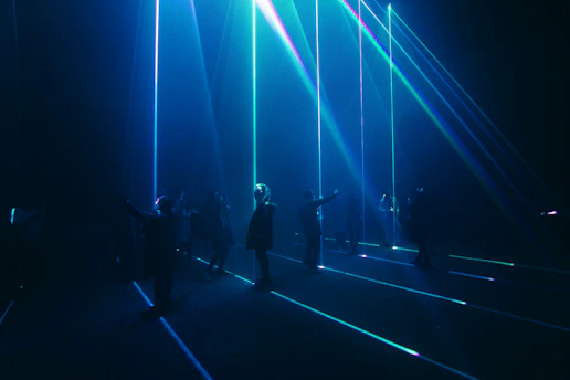 A dynamic group of players wearing lasertag gear in a futuristic arena, engaging in a team battle.