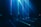 A group of people stand in a dark room with vibrant blue and green laser beams projecting vertically and horizontally around them. The atmosphere is immersive and futuristic, with shadows and light creating a dramatic effect.