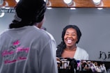 Smiling woman looking confidently at her reflection in a mirror.